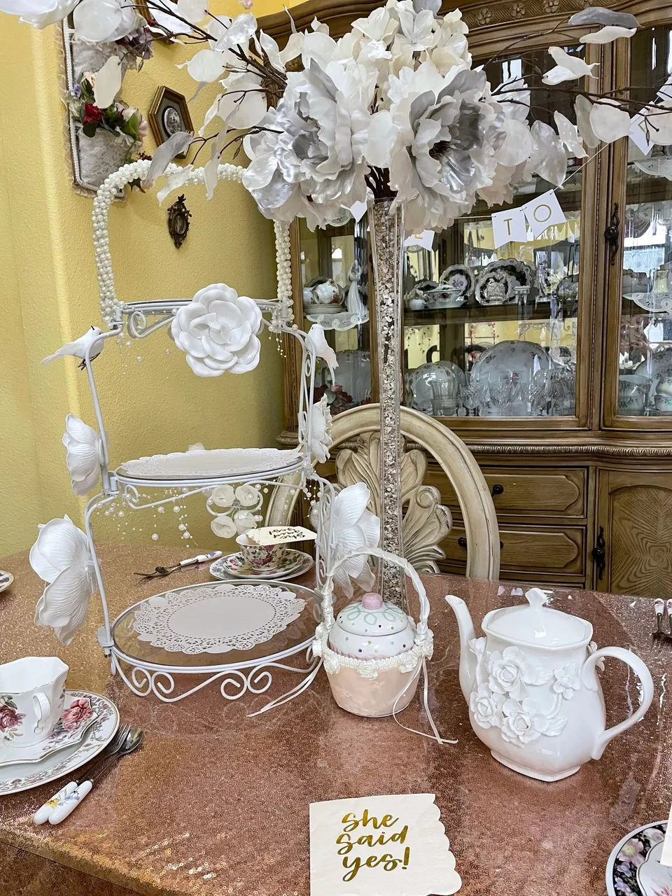 Bridal shower table with floral china and a white blossom centerpiece