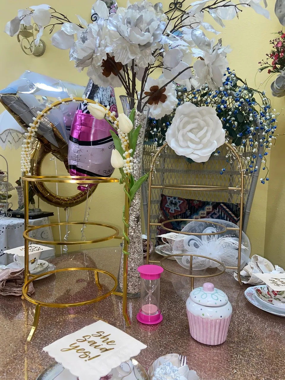 Decorated tea stand, teapot and white flowers for a private celebration