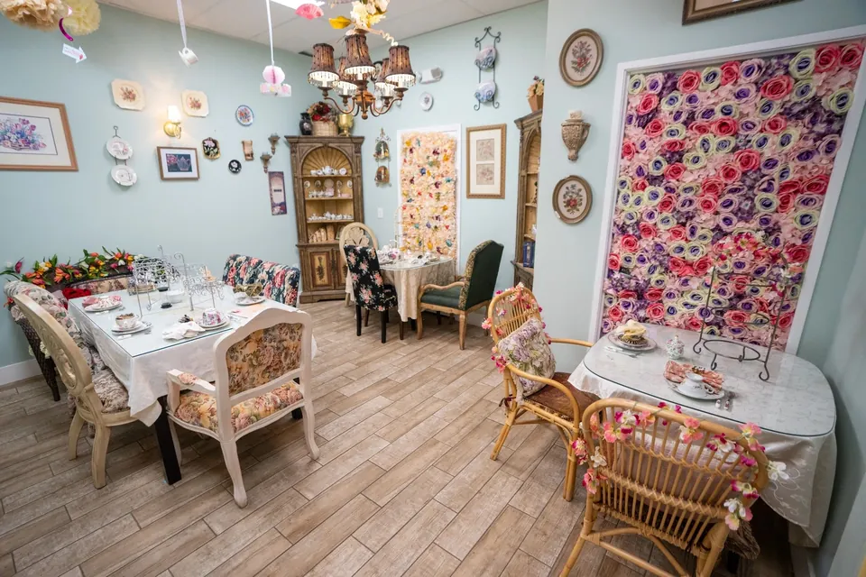 Floral tea room with vintage chairs and tables set for afternoon tea at The Tea Terrace in Las Vegas